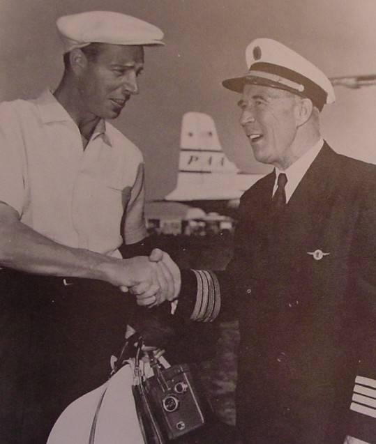1950s Joe DiMaggio shaking hands with a  with Pan Am Captain.